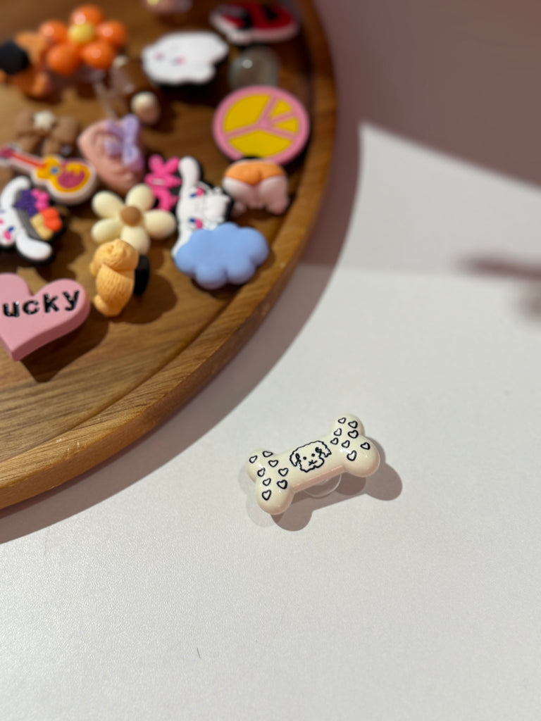 Dog bone Croc charm with hearts and puppy face.