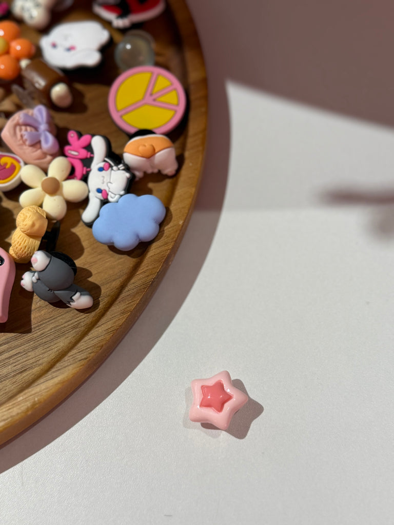 Pink star Croc charm with a darker pink centre.