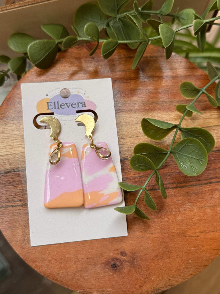 Polymer clay drop earrings in pastel pink, peach and white marble design with gold accents.