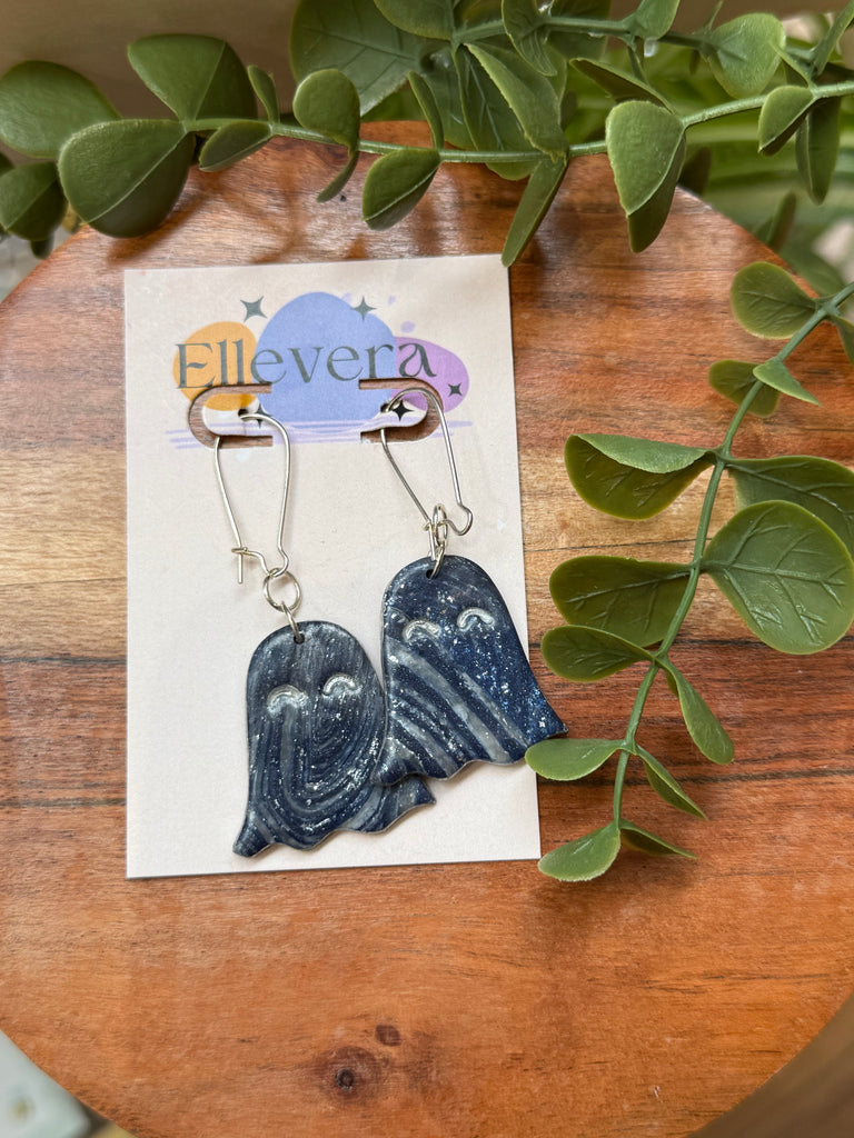 Polymer clay ghost earrings with galaxy design and silver hooks.