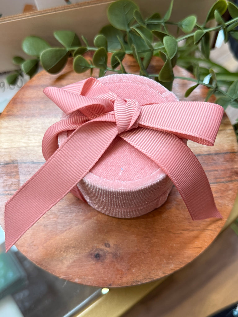 Pink velvet jewellery gift box with ribbon bow.