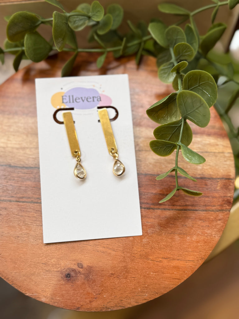 Gold bar drop earrings with teardrop crystal detail.