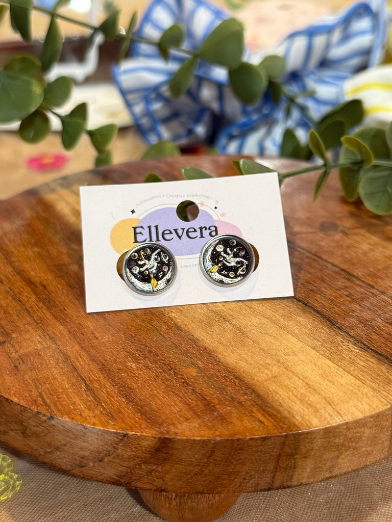 Black and silver galaxy swirl stud earrings with celestial star design.