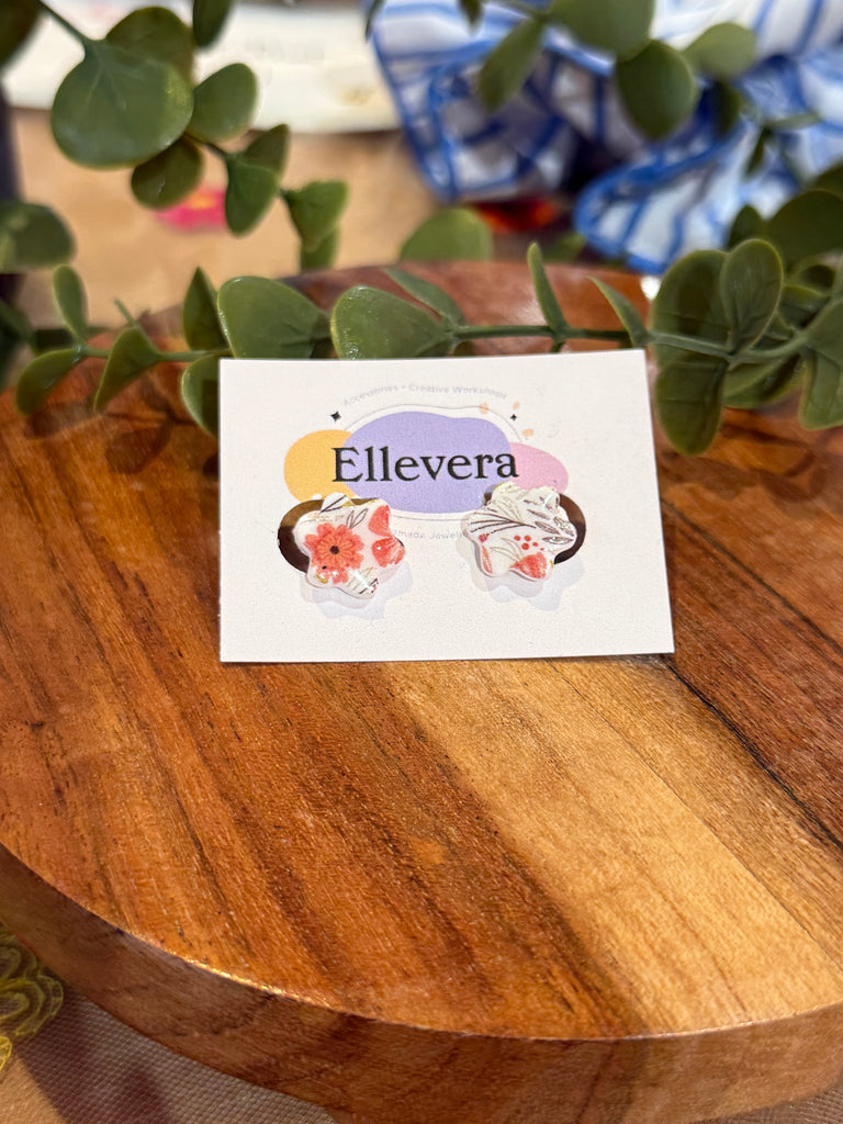 Red floral patterned handmade stud earrings on Ellevera backing card.