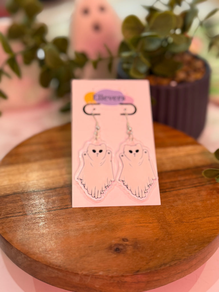White ghost-shaped Halloween earrings on hooks, displayed on Ellevera card.