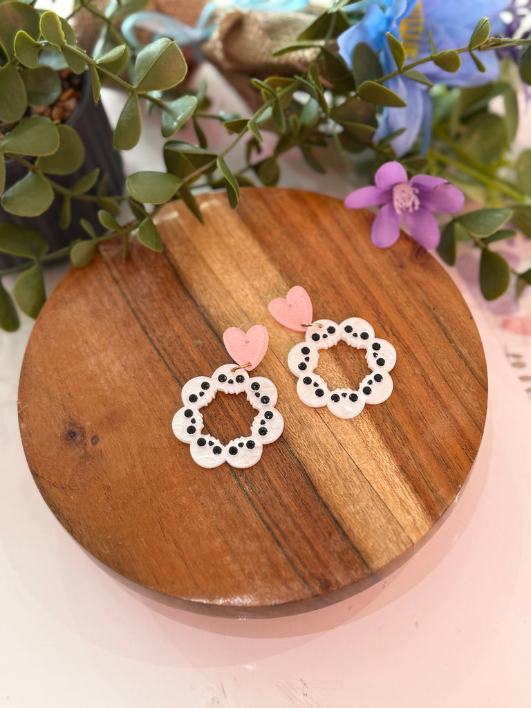 Heart stud earrings with a skull wreath design