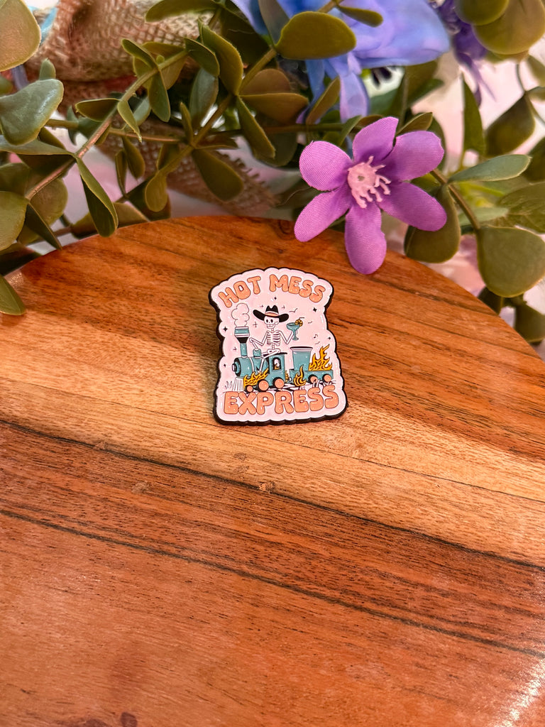 Enamel pin with skeleton cowboy and text “Hot Mess Express.