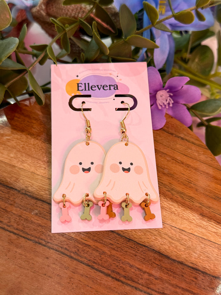 Pair of ghost-shaped drop earrings with pink, green, and gold dangling charms.