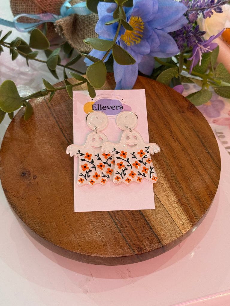Ghost-shaped earrings with orange floral patterns.