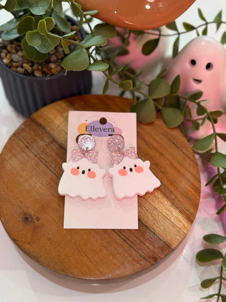 Resin ghost earrings with glitter and floral detail in yellow oval frame on Ellevera display card.
