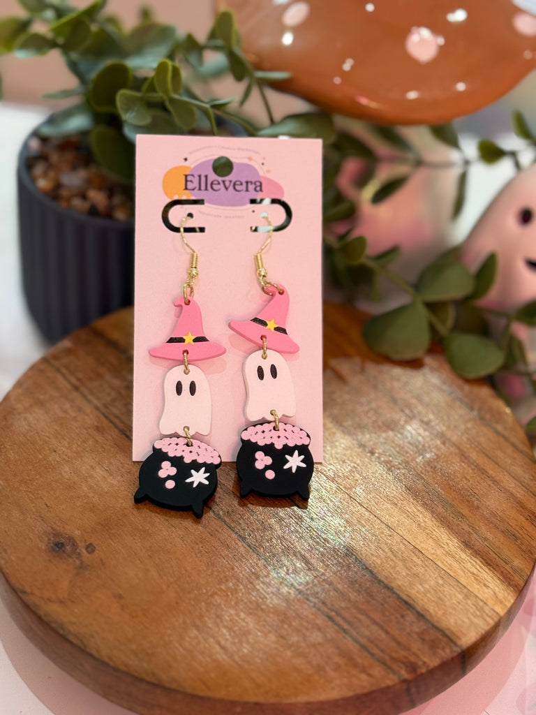 Pink witch cauldron ghost earrings with pastel hats and bubbling cauldrons on Ellevera display card.