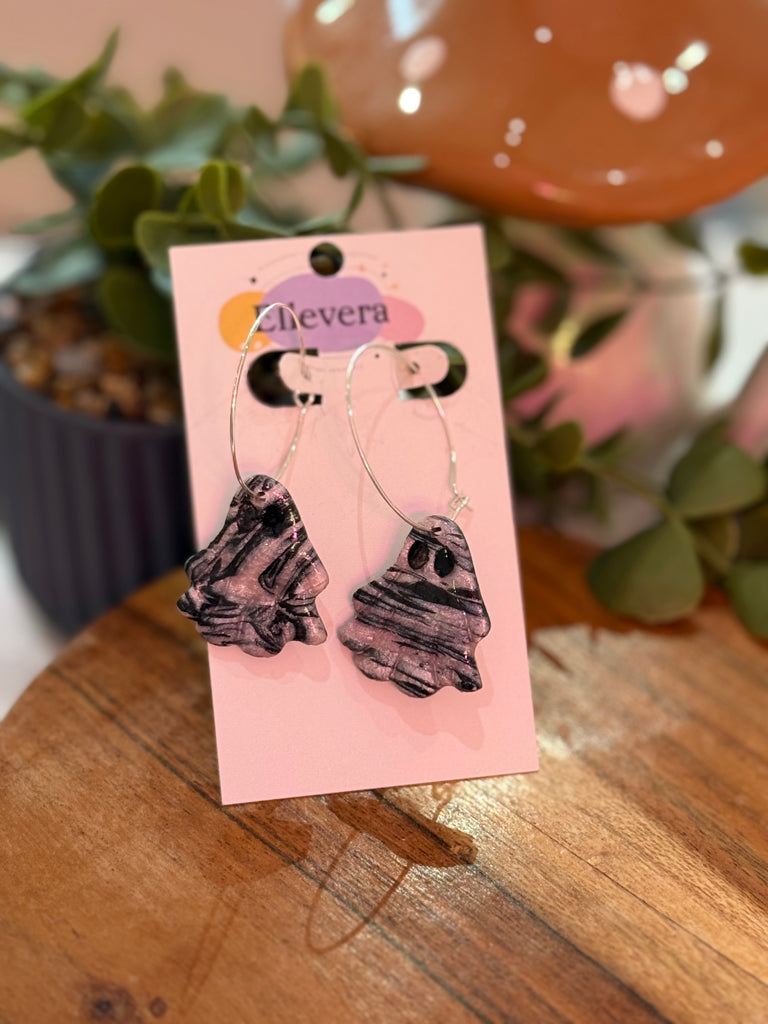Polymer clay ghost earrings in black and grey marble effect on silver hoops displayed on Ellevera card.