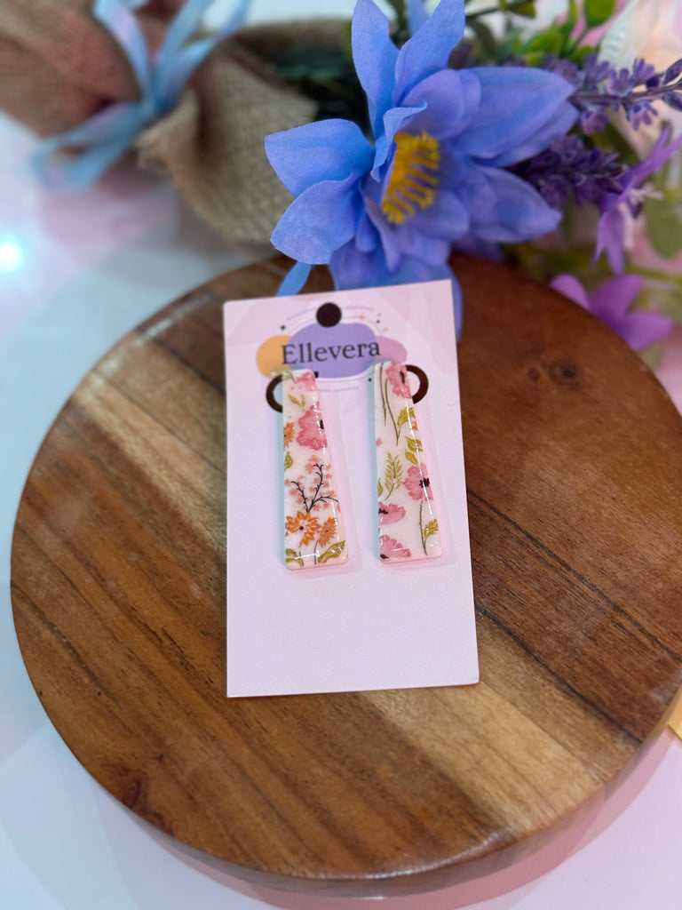 Handmade floral polymer clay rectangle earrings with pink and orange flower design on Ellevera backing card.