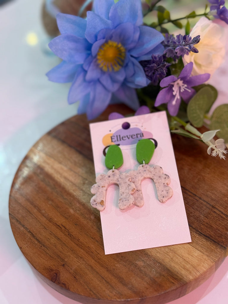 Green and speckled white polymer clay arch earrings on Ellevera backing card