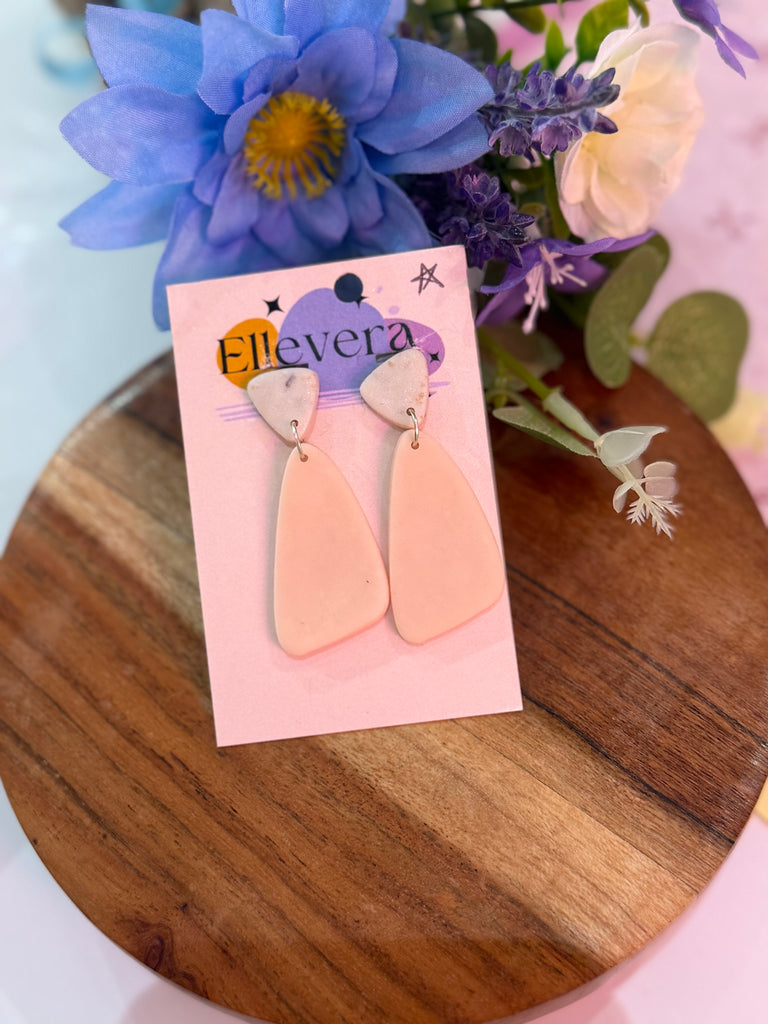 Handmade blush pink polymer clay geometric earrings on Ellevera backing card.
