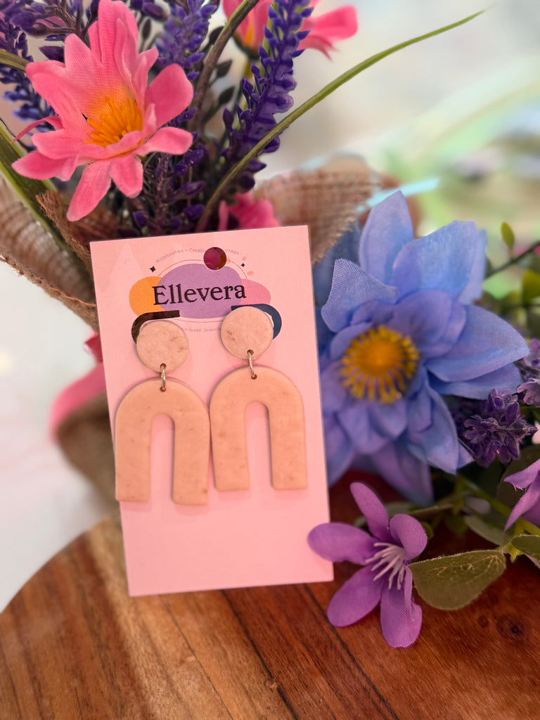Handmade blush pink arch polymer clay earrings on Ellevera backing card.
