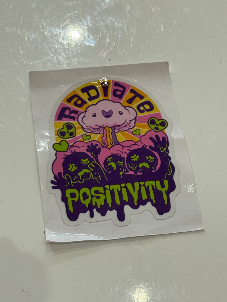 Radiate Positivity sticker with kawaii mushroom cloud design in neon pink, yellow, and purple.