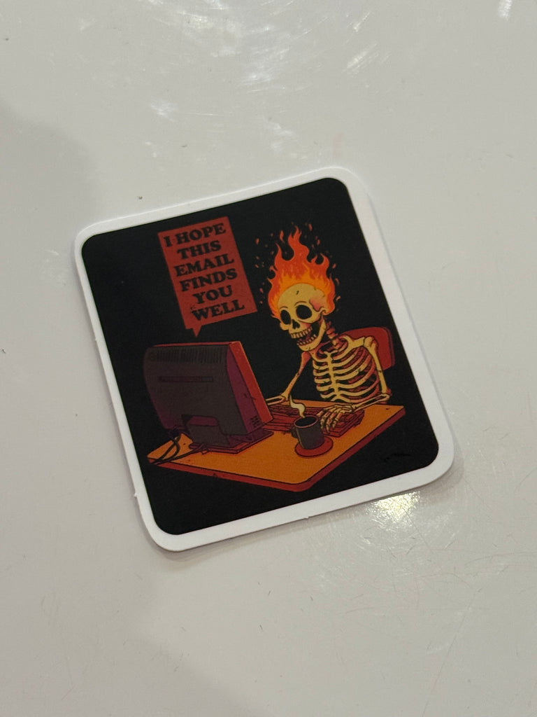 Sticker with skeleton at a computer on fire reading “I hope this email finds you well.”