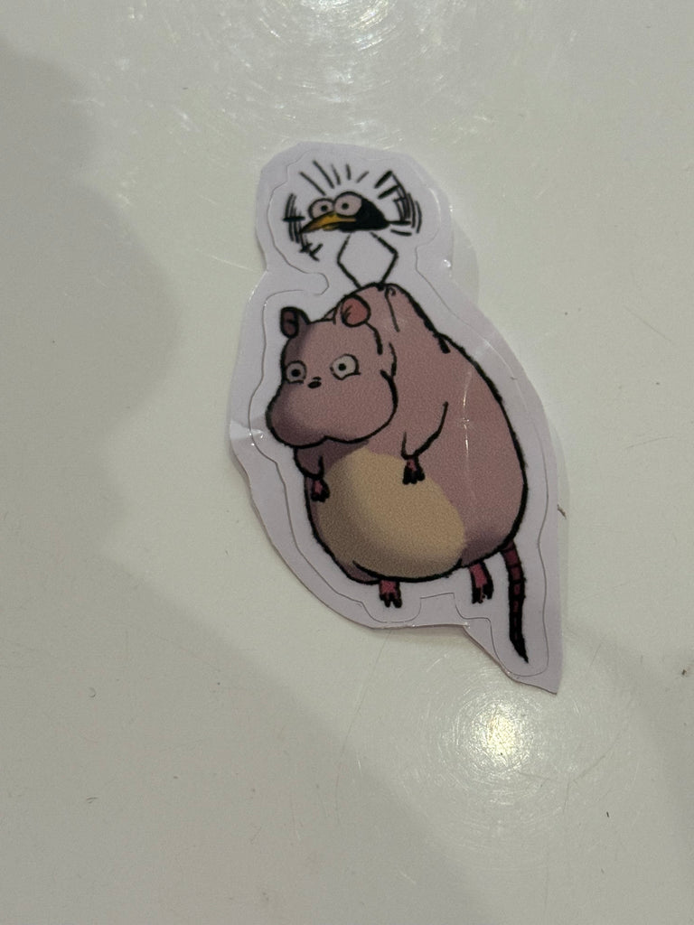 Cartoon sticker of a plump forest creature with a bird in Studio Ghibli–inspired style.