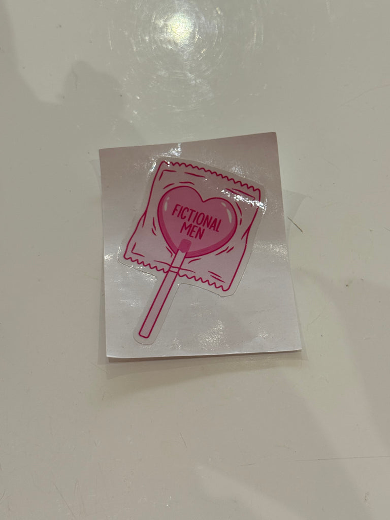Pink heart lollipop sticker with the words Fictional Men.
