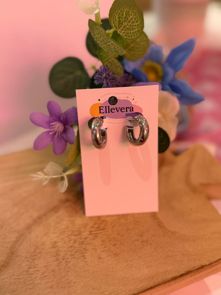 Silver chunky hoop earrings displayed on Ellevera backing card.