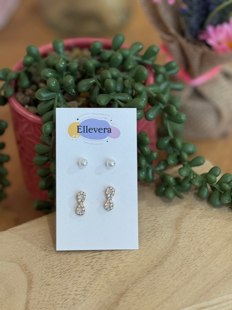 Set of two stud earrings displayed on Ellevera card – one pair of pearl studs and one pair of crystal infinity studs.