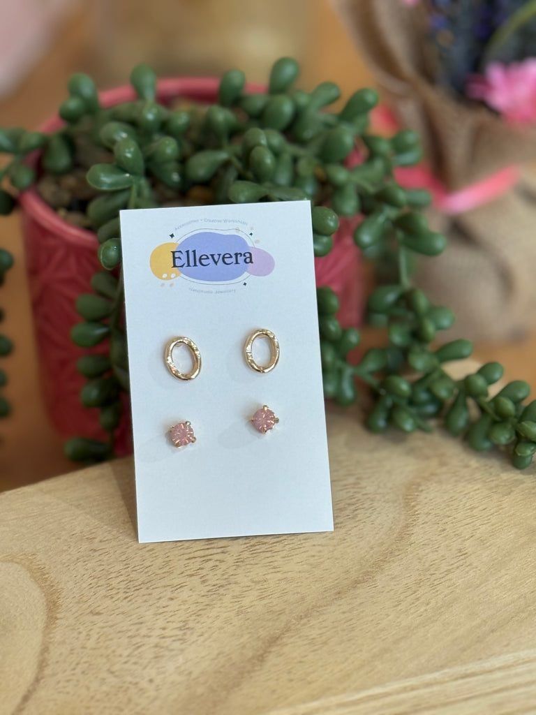 Set of two stud earrings on Ellevera card – one pair of textured gold oval studs and one pair of pink gemstone studs.