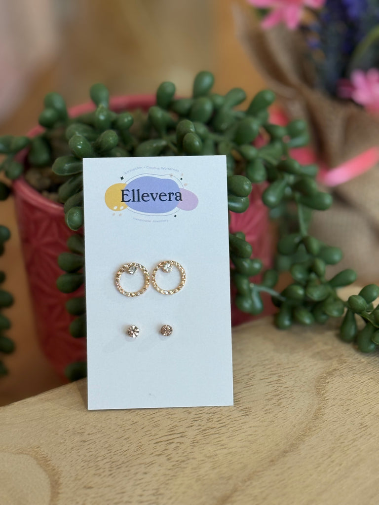 Two-pair earring set on Ellevera card – one pair of gold open circle studs with crystals and one pair of small gold flower studs.