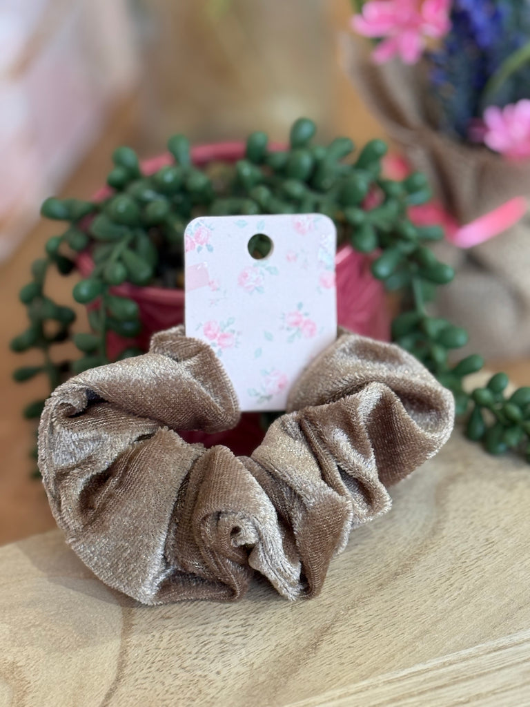 Mocha brown velvet scrunchie displayed on floral backing card.