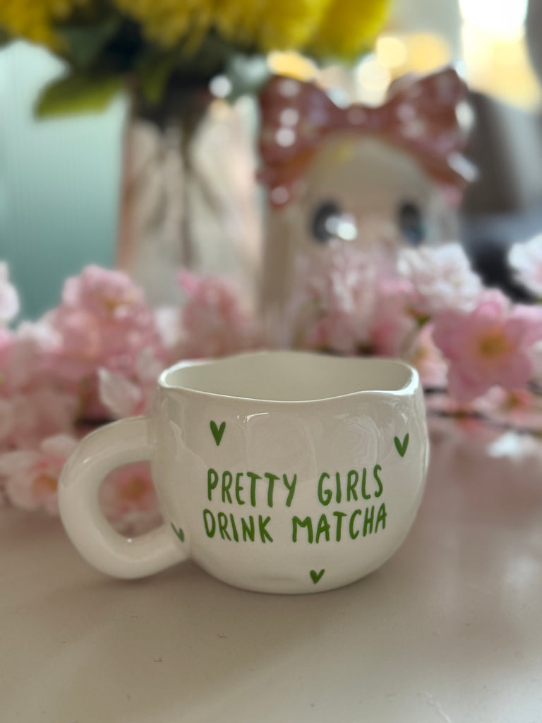 White ceramic mug with the words "Pretty Girls Drink Matcha."