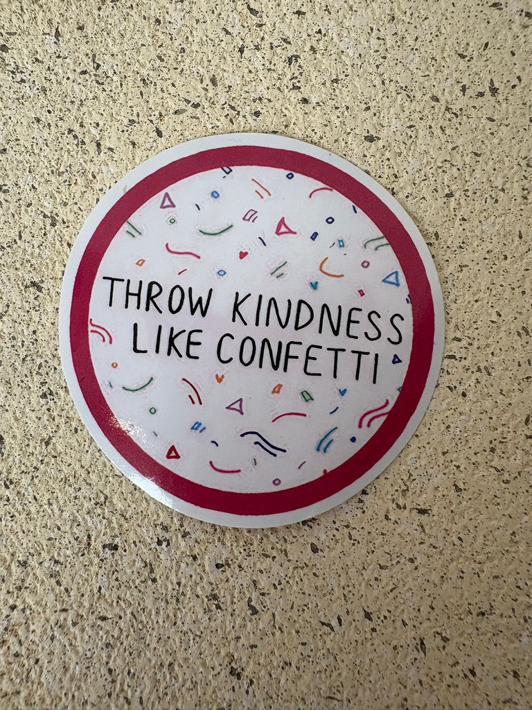 Round sticker with text “Throw kindness like confetti” and colourful confetti details.