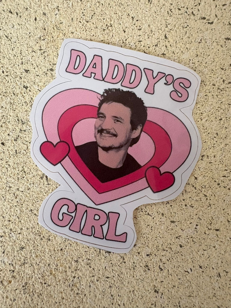 Sticker with Pedro Pascal inside a pink heart design with text “Daddy’s Girl.”